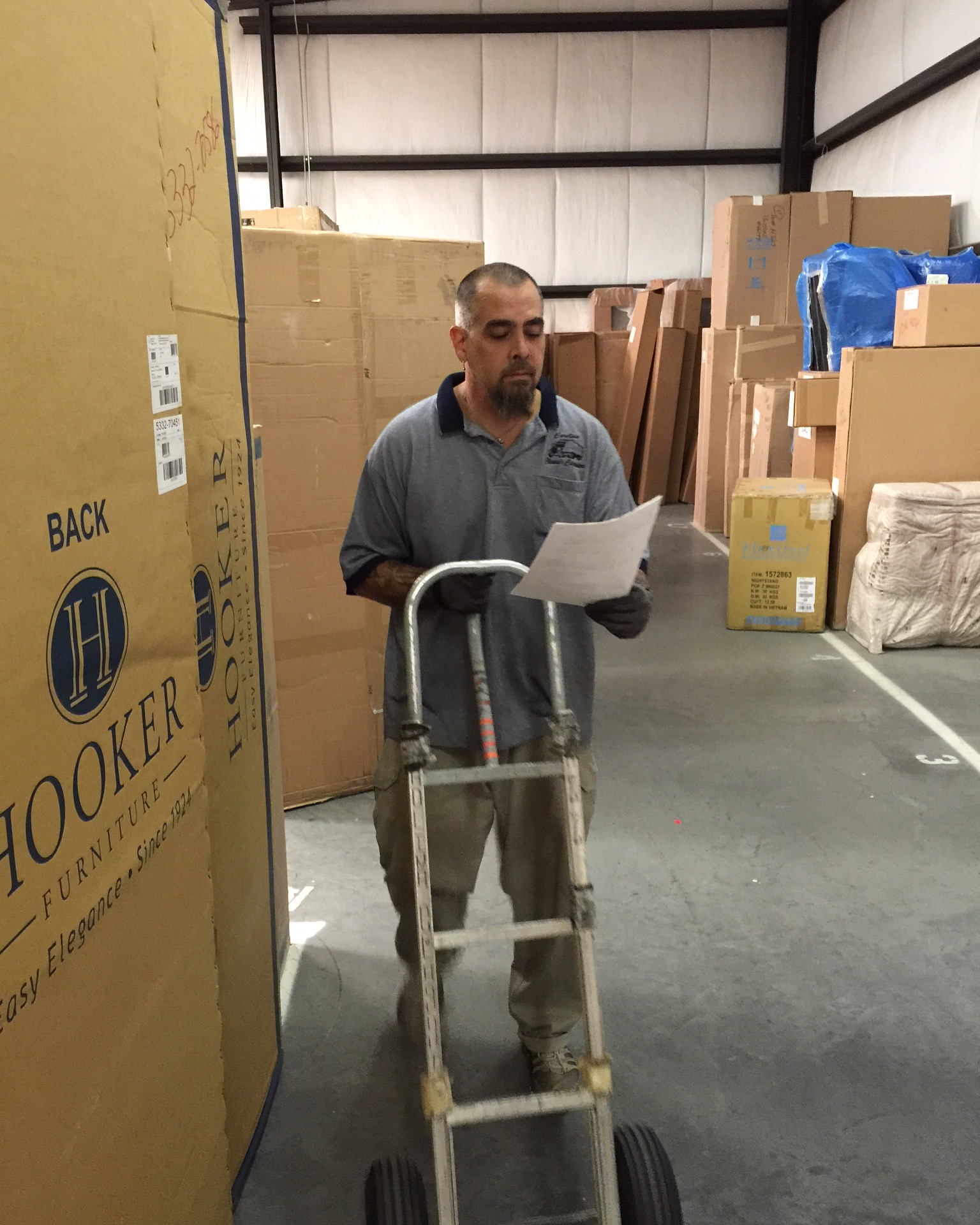 Warehouse employee reviewing paperwork